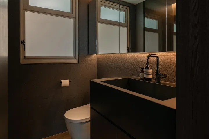 Its pared-back material palette and clean detailing reinforce the sense of quiet simplicity carried through the master bedroom.