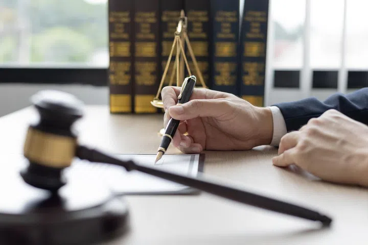 Lawyers or judges sign documents in accordance with legal and fair terms of agreement, Legal Ethics and Integrity, scales of justice, law hammer, Litigation and legal services.
