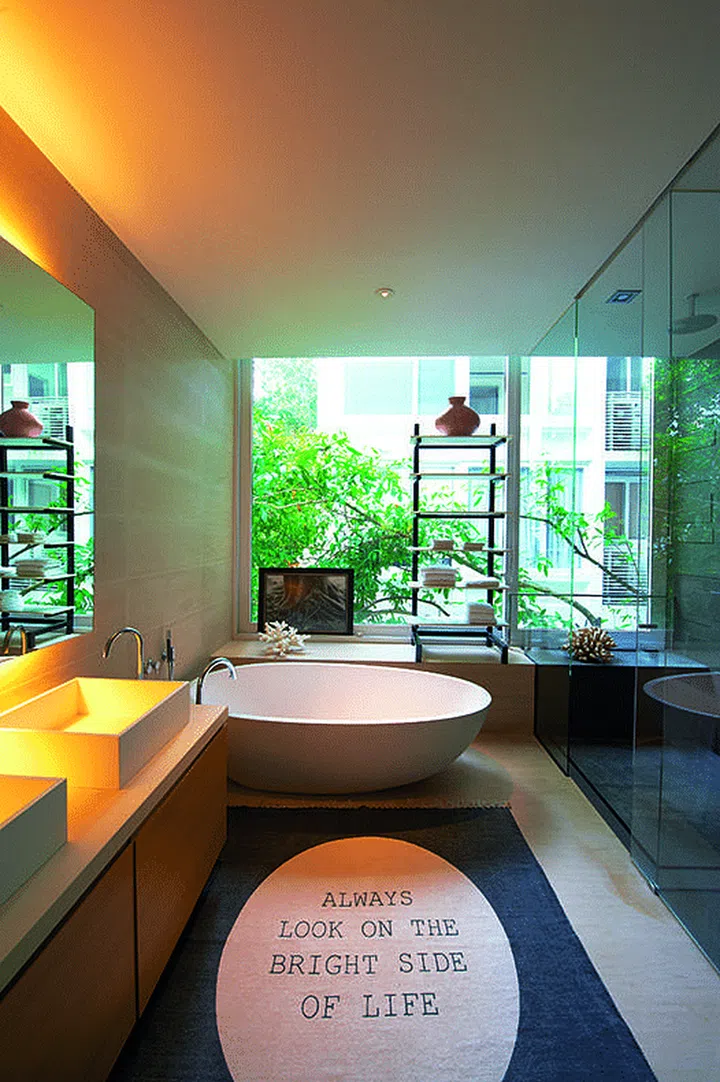 The large windows in the master bathroom of this four-bedroom apartment lets the outside in, creating a verdant sun-drenched oasis. Interior Design: Viterbo