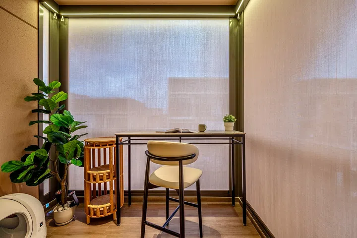 Roller blinds provide shade and privacy, transforming the balcony into a cosy extension of the living space.