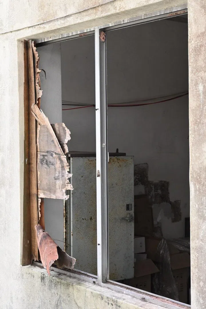 A broken window of an abandoned bungalow behind the HDB block at Spooner Road. Photo by Isabel Lim