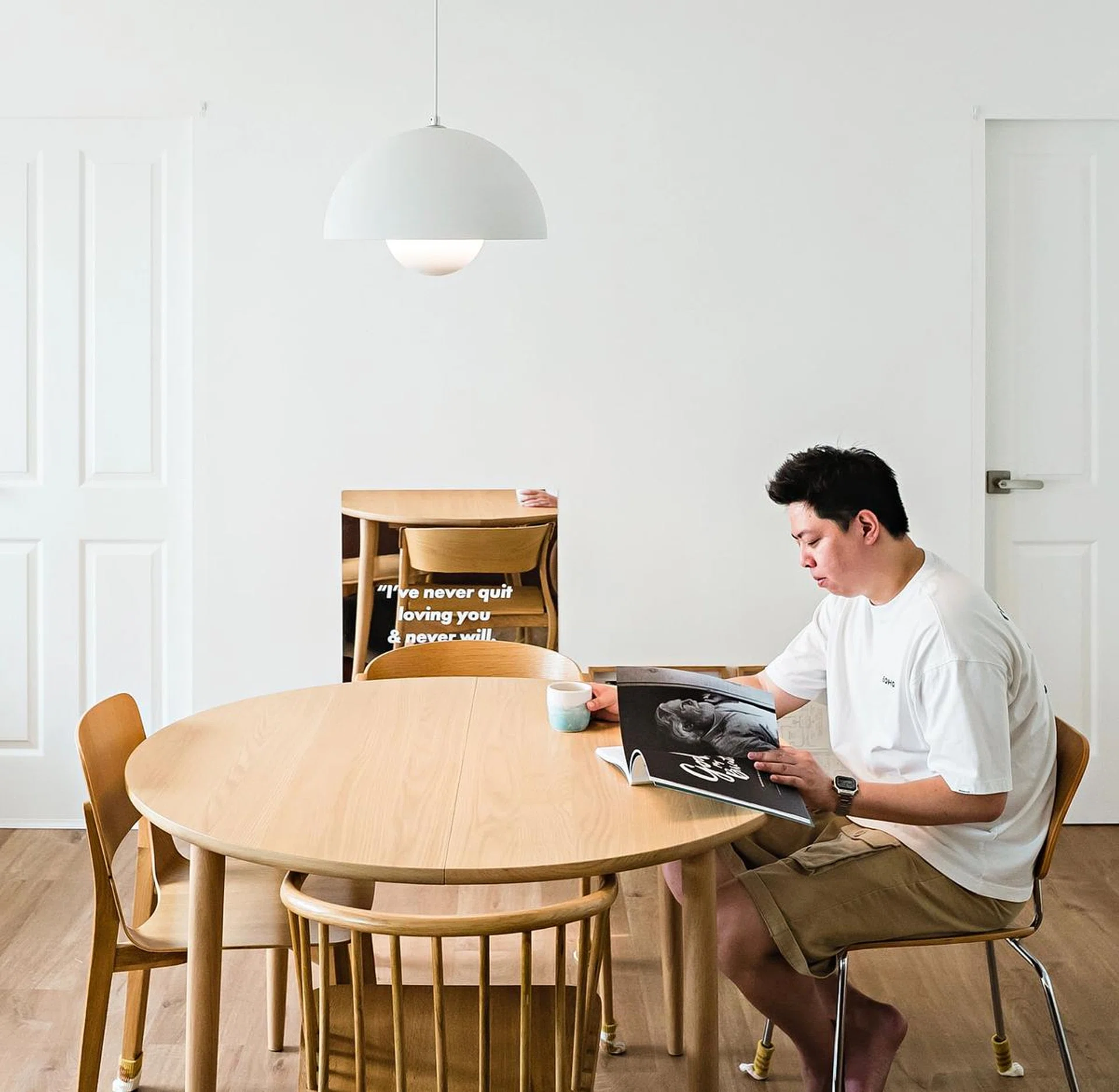The bedroom doors in white blend in with the walls, keeping the dining area looking spacious and uncluttered.