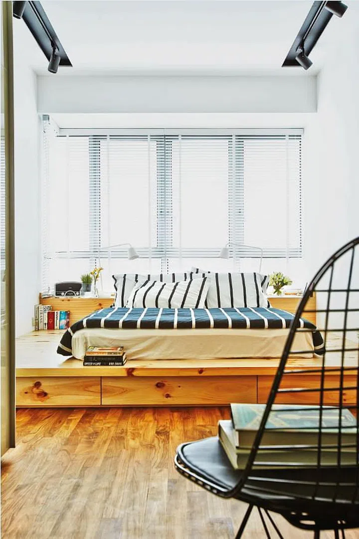 The platform in the master bedroom gives the space a loft-like feel, while incorporating storage space within. Interior design by Museum Homes.