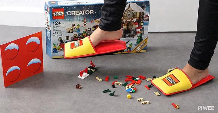yellow and red lego slippers placed on lego blocks