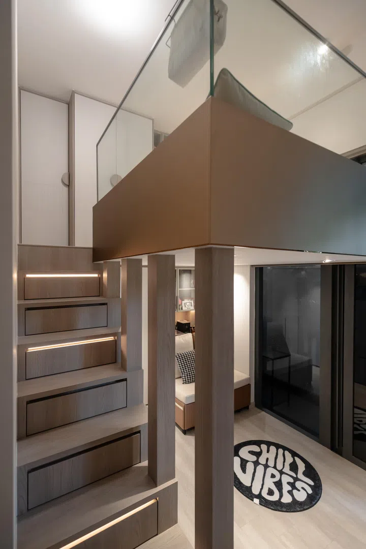 Custom carpentry makes every inch work harder, with storage built into the staircase and a loft structure designed to feel sturdy without overwhelming the room.