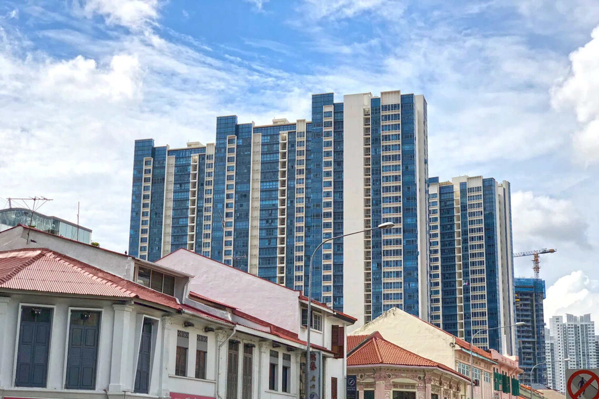 Singapore modern housing residential blocks behind row of old shop house - fusion/ contrast concept.
