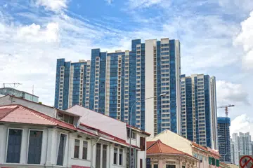 Singapore modern housing residential blocks behind row of old shop house - fusion/ contrast concept.