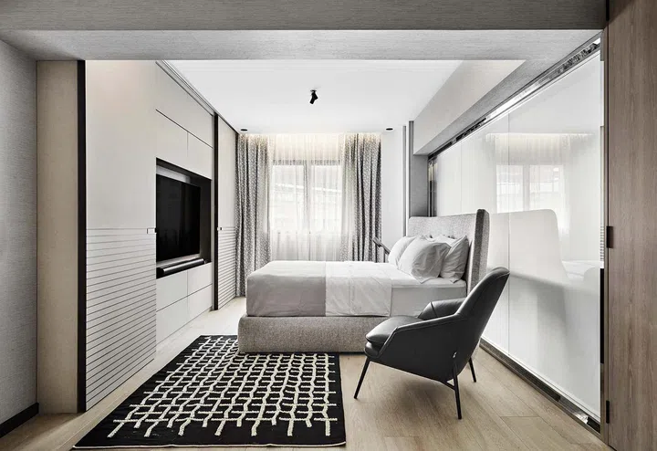 The master suite with a spacious, L-shaped configuration.