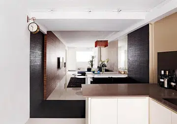 The white walls are complemented by warm tones, such as the wood-like walls and tassel ceiling lamp.