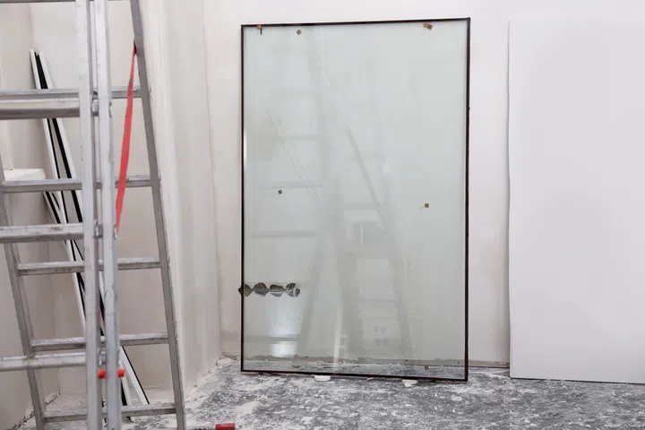 Double glazing window on floor near wall indoors