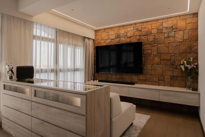 The textured stone feature wall anchors the room in warm, earthy tones, complemented by the boutique-style glass chest of drawers Mr Lin loves.