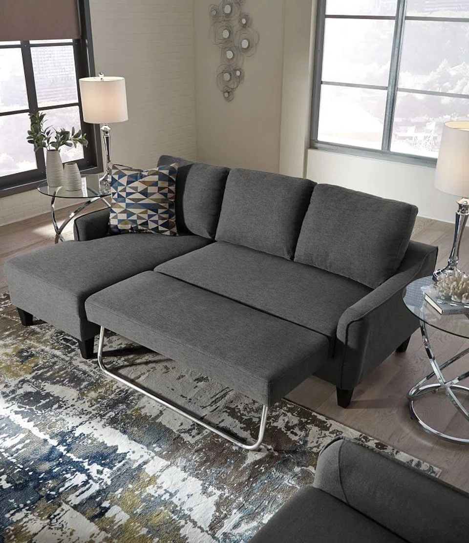 Ashley Furniture Jarreau Sofa Chaise Sleeper (RRP: $1,399). Dimension: W210 x D 135 x H 91 cm. Loose cushions. High-resiliency foam cushions Polyester upholsteryIncludes a pullout cushion that sits atop a supportive steel frame. Exposed feet with faux wood finish.