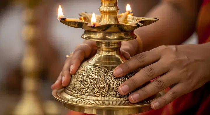 Traditional Indian brass oil lamp known as a Kuthu Vilakku