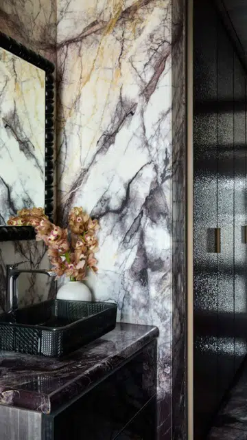 The intricate design extends to the private spaces too, such as in this cosy and luxurious powder room. 