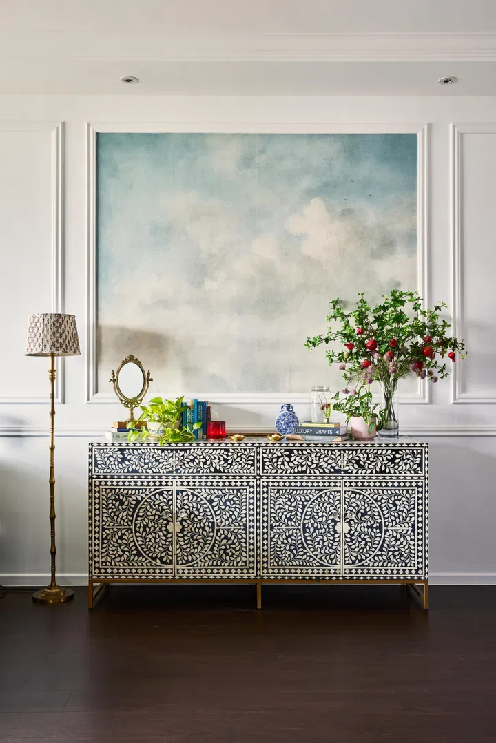 A bone inlay headboard is positioned next to the couch.