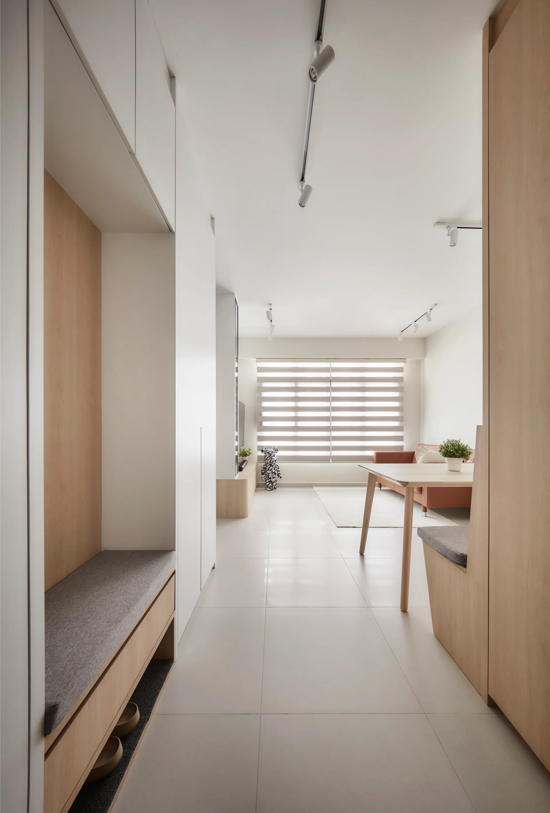 A custom shoe cabinet with a built-in settee makes the entryway both practical and welcoming.
