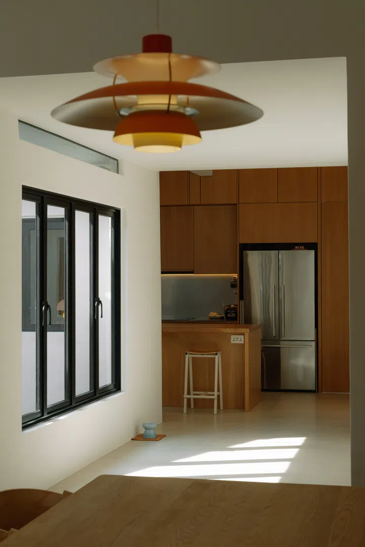 The kitchen sits immediately beside the entrance, making it the first space to welcome them home.