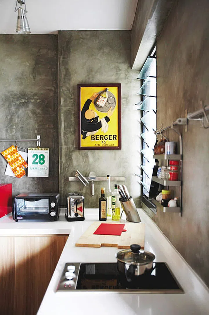 This vintage-style advertising sign, purchased in Sri Lanka, adds colour to the wall. 