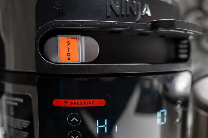 The Ninja Foodi SmartLid Slider determines the presets that will show up on the screen below it.