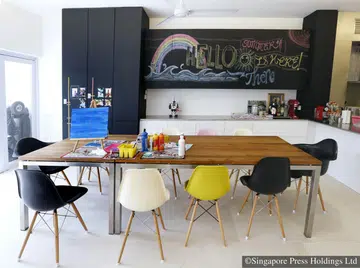 A 10-seater dining table that doubles as a play table for the children of Ms Shi Xiao Wei and her husband Dickson Seow.
