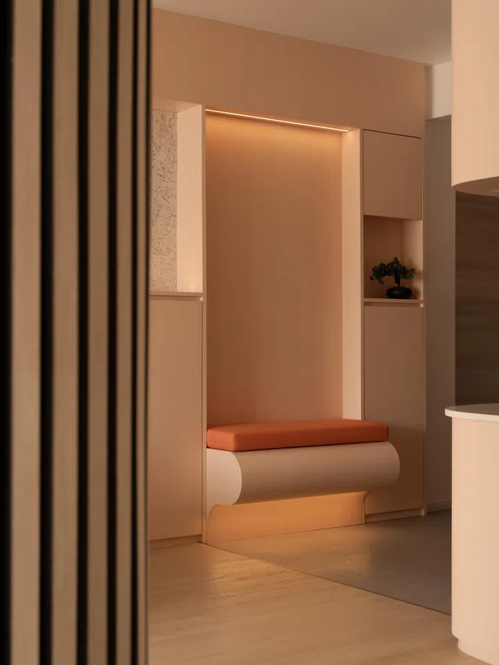 The custom shoe-changing niche incorporates seating and subtle under-seat lighting, giving everyday routines spatial clarity and comfort.