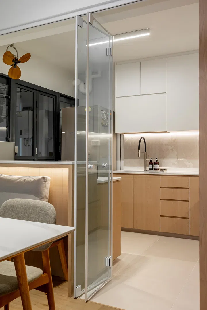 Glass doors separate the kitchen and dining room in Mr and Mrs Chua’s 4-room BTO in Tampines.