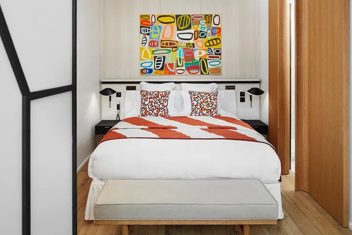 Can't commit to a coloured wall? Opt for art and printed bed linen.