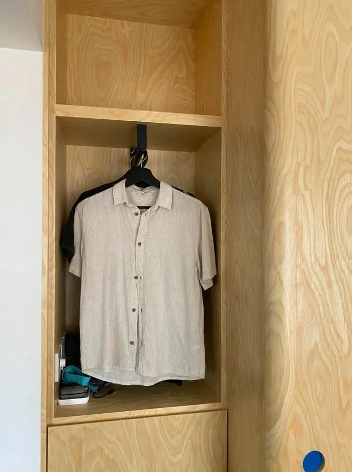 In this 2-room HDB in Sengkang, Jade Cham from Knock Knock Studio built the wardrobe with an open cabinet at one end.