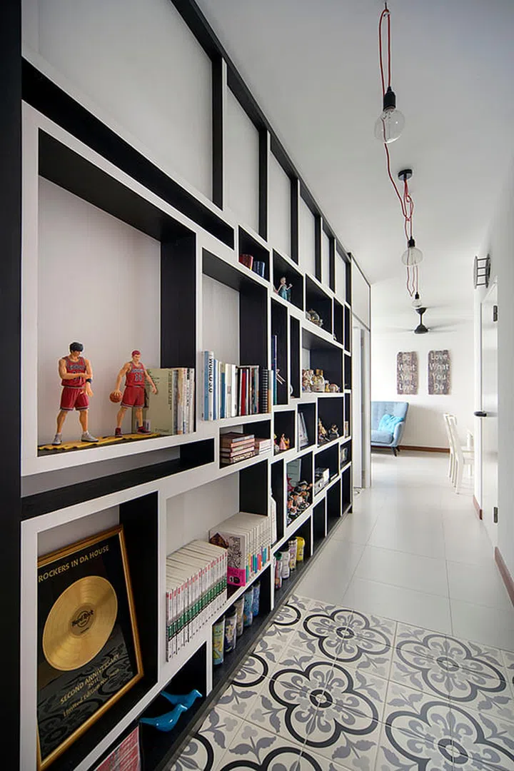 Because of the owner's love of collectible items, an open display shelf is custom designed to run along the walkway of their 4 room HDB for additional storage space. Interior design by The Scientist