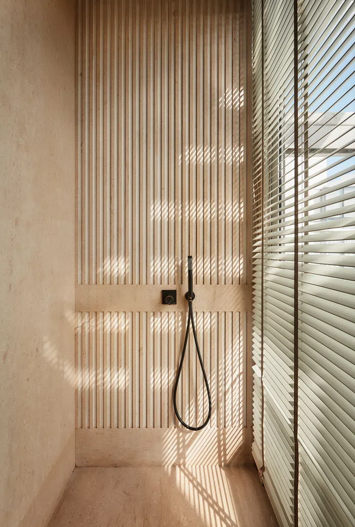 The play of light and shadow on the marble shower wall in the master bathroom creates an interesting and ephemeral effect.