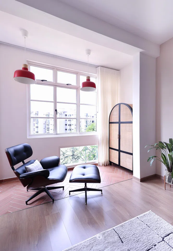 The former balcony is now a cosy reading corner, distinguished by terracotta floor tiles and views of Bukit Timah Nature Reserve.