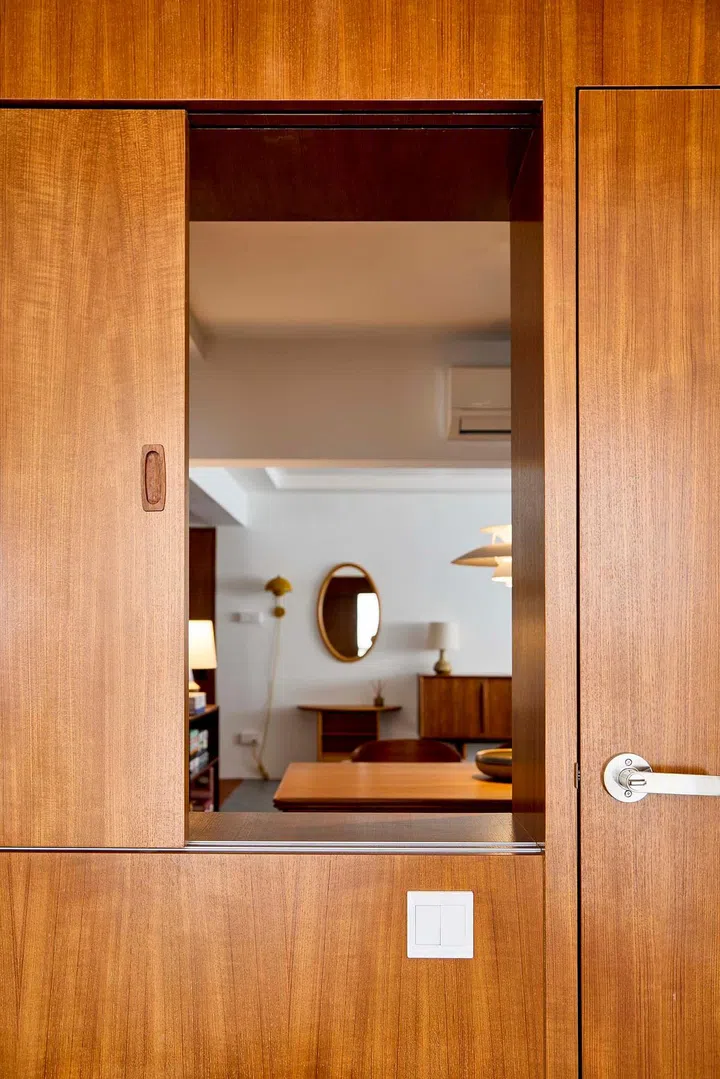 The sliding windows separate the private bedroom and the public study space.