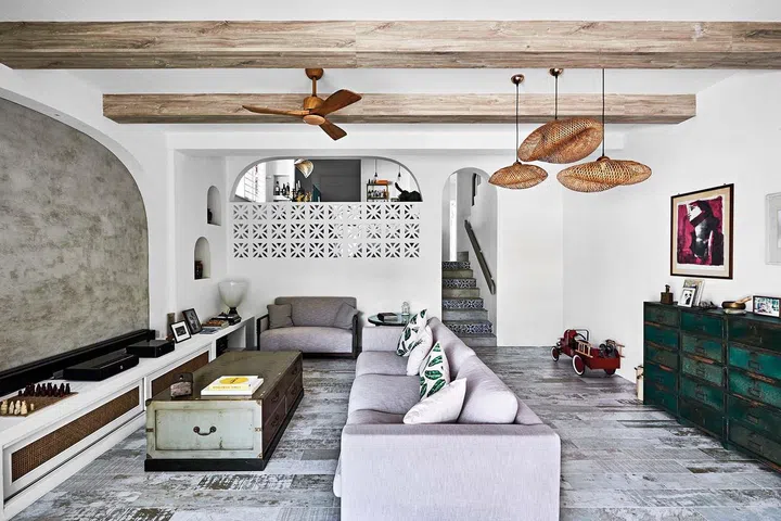 In the living room sits a side table with a clock face that the couple had bought on honeymoon in Mykonos, and next to it is a love seat with intricate carvings that Georgina bought in Shanghai.