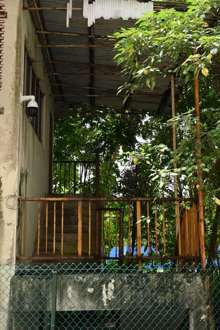 The staircase (and security camera) of the abandoned bungalow building at Spooner Road. Photo by Isabel Lim