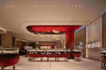 On the ground floor, a high-gloss red lacquer ceiling anchors the room, illuminated by a custom Sans Souci crystal chandelier designed to mirror sunlight filtering through a bamboo grove.