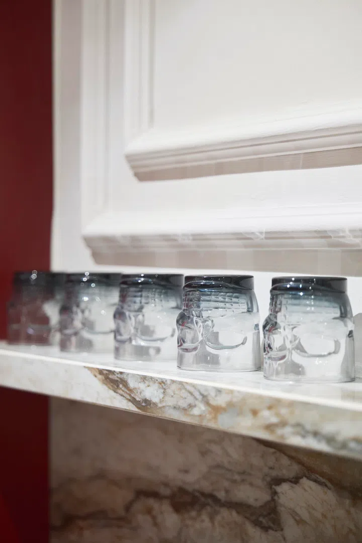 Skull-shaped glassware continues the recurring motif, integrated into everyday use rather than treated as purely decorative.