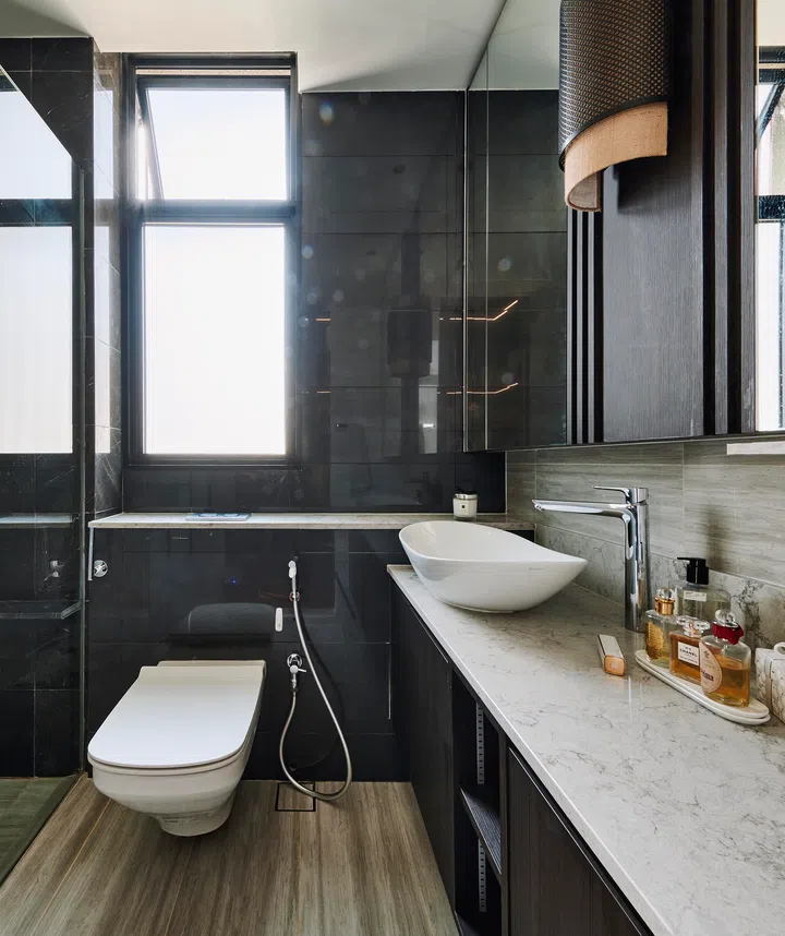 Resort-style finishes and a rare fabric wall lamp create a spa-like escape to “wash away the grind of life.”