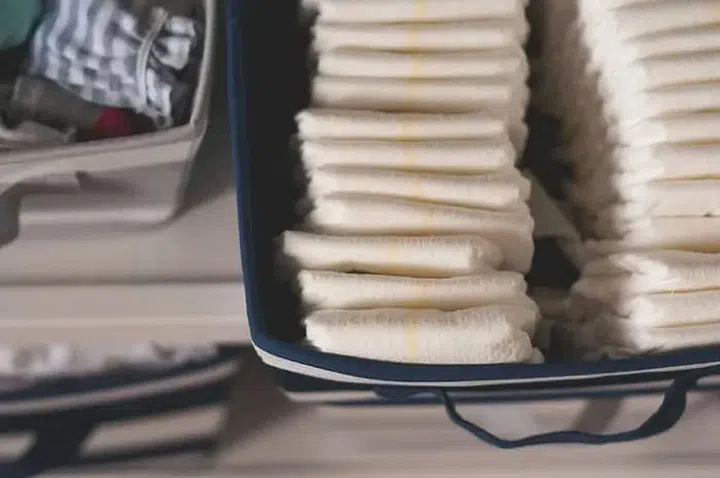 A tray of neatly organised disposable baby diapers in boxes. Image: Getty