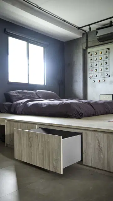 An elevated platform bed with storage space underneath the platform in flight attendant Kenny Shoo’s 3-room HDB flat at Tampines Street 41.