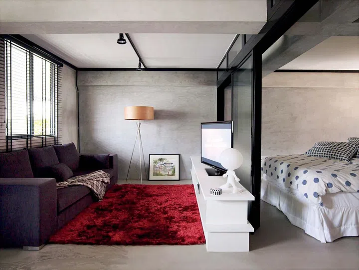 Living and bedroom in a 700 sq ft 3-room HDB bachelor's pad.