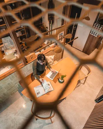 From above, the compact dining area doubles as a work surface—a reminder that every corner must earn its keep in a small home.