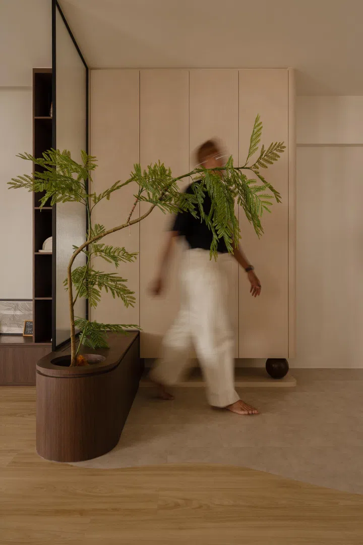 A curved transition in vinyl flooring defines the foyer as a practical shoe-on zone, subtly separating the entry from the rest of the home.