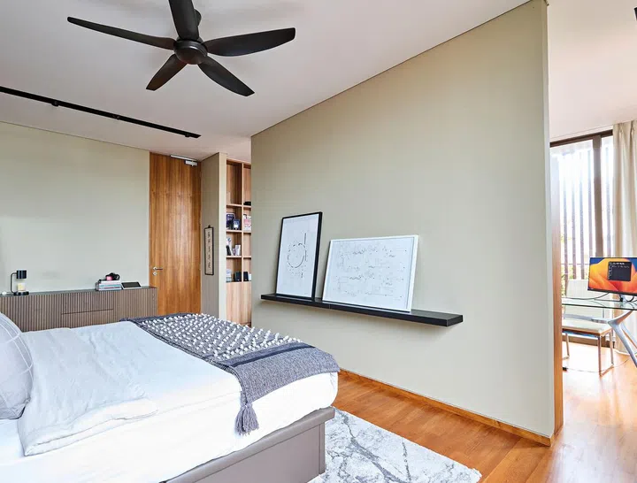 An internal wall separates the sleeping area from the home office within Sharne’s room.