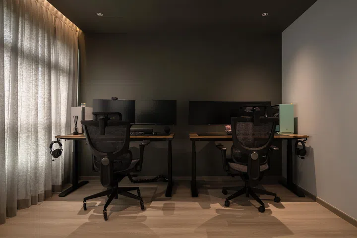 The home office with matching gaming desks and chairs. 