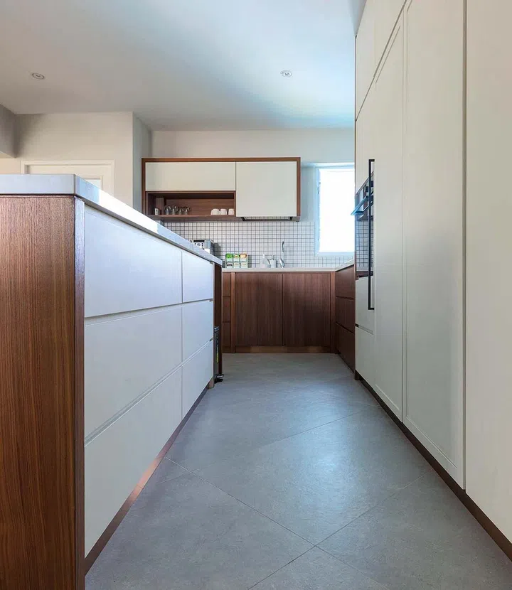 The diagonal layout of the flooring tiles provide an interesting contrast with the kitchen cabinetry.
