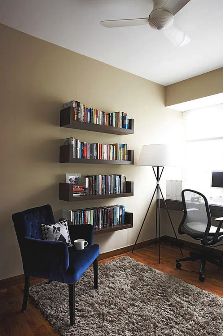 The bay window was turned into a desk where the husband can work at night without disturbing his spouse. Coffee hues, from espresso-dark wood furniture to cafe au lait walls, tie the look together.