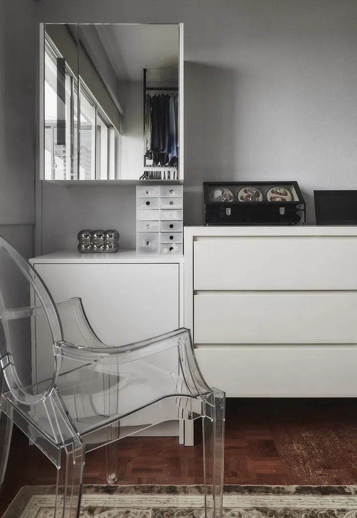 A dressing table with a Philippe Starck Louis Ghost chair in the walk-in wardrobe in this 1,650 sq ft 3-bedroom Marine Parade condo.