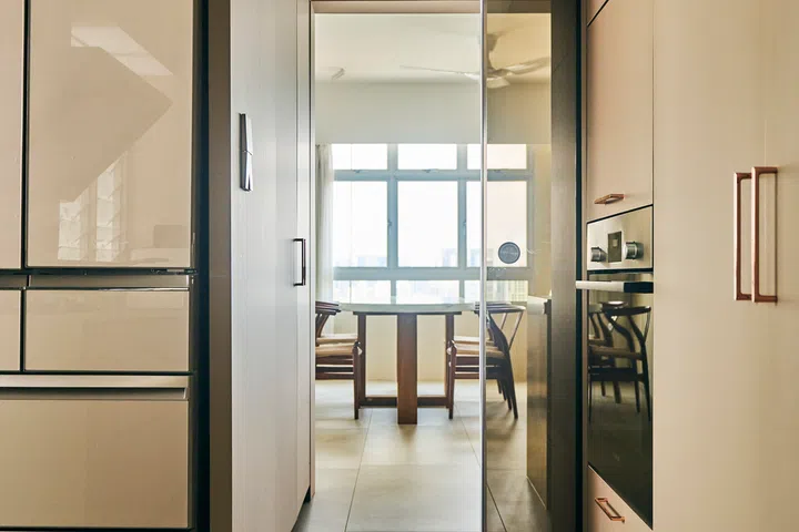 A glass sliding door stops cooking smells from entering the main chamber of the house.