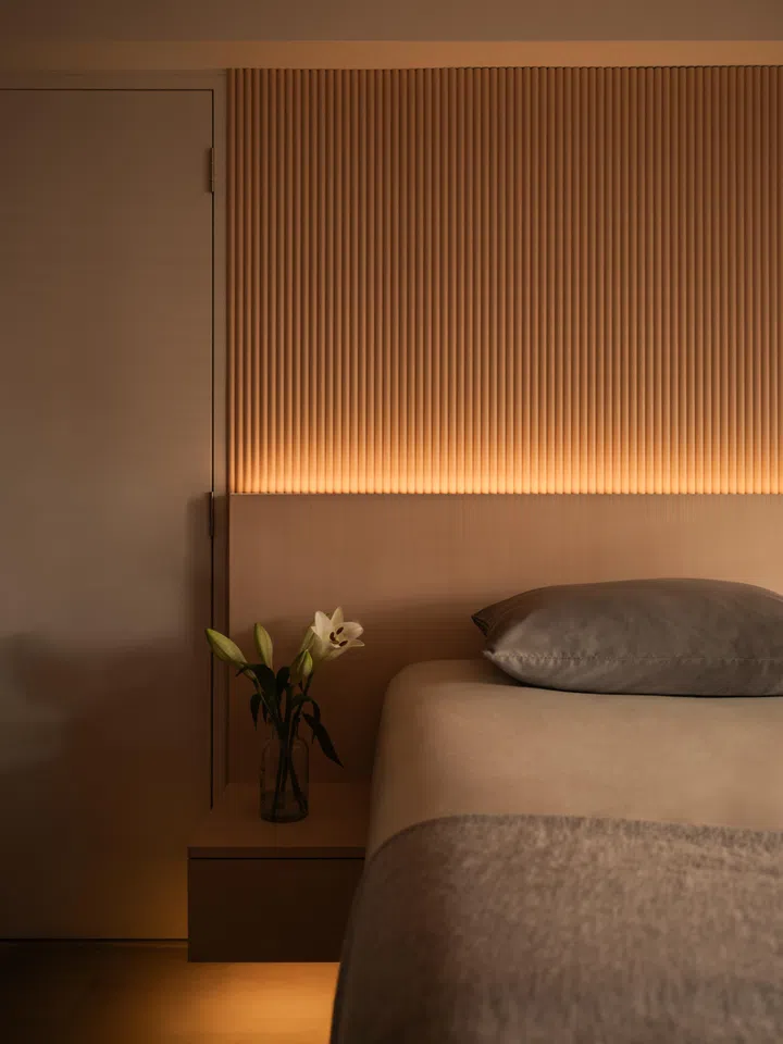 A restrained palette of timber and warm neutrals carries through into the master bedroom, creating a calm, unified backdrop that Joanne finds most restful.