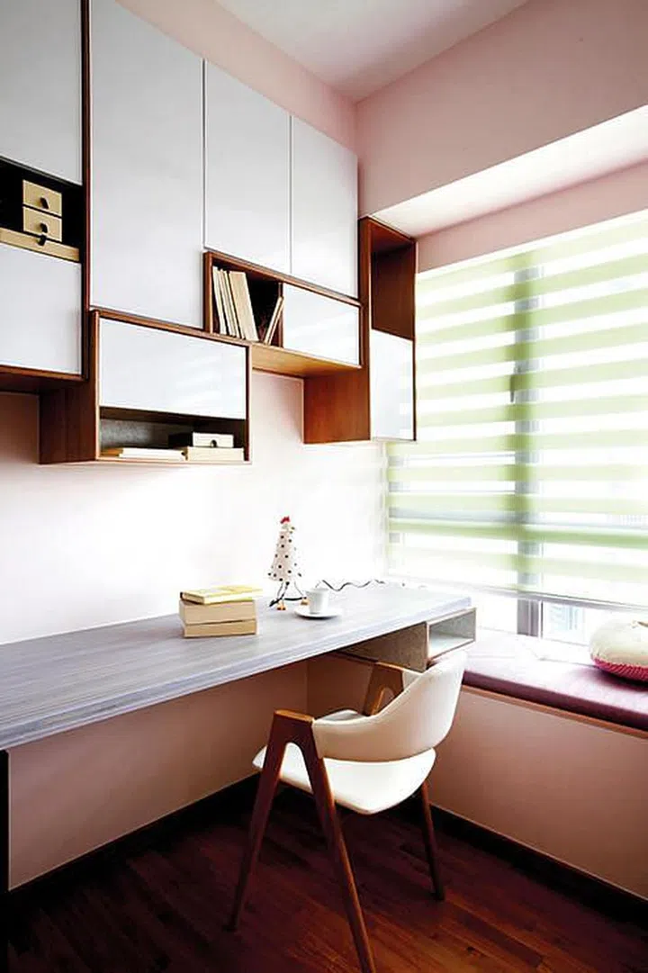 Built in wood study table and bay window seat with storage. Interior design by Prozfile.